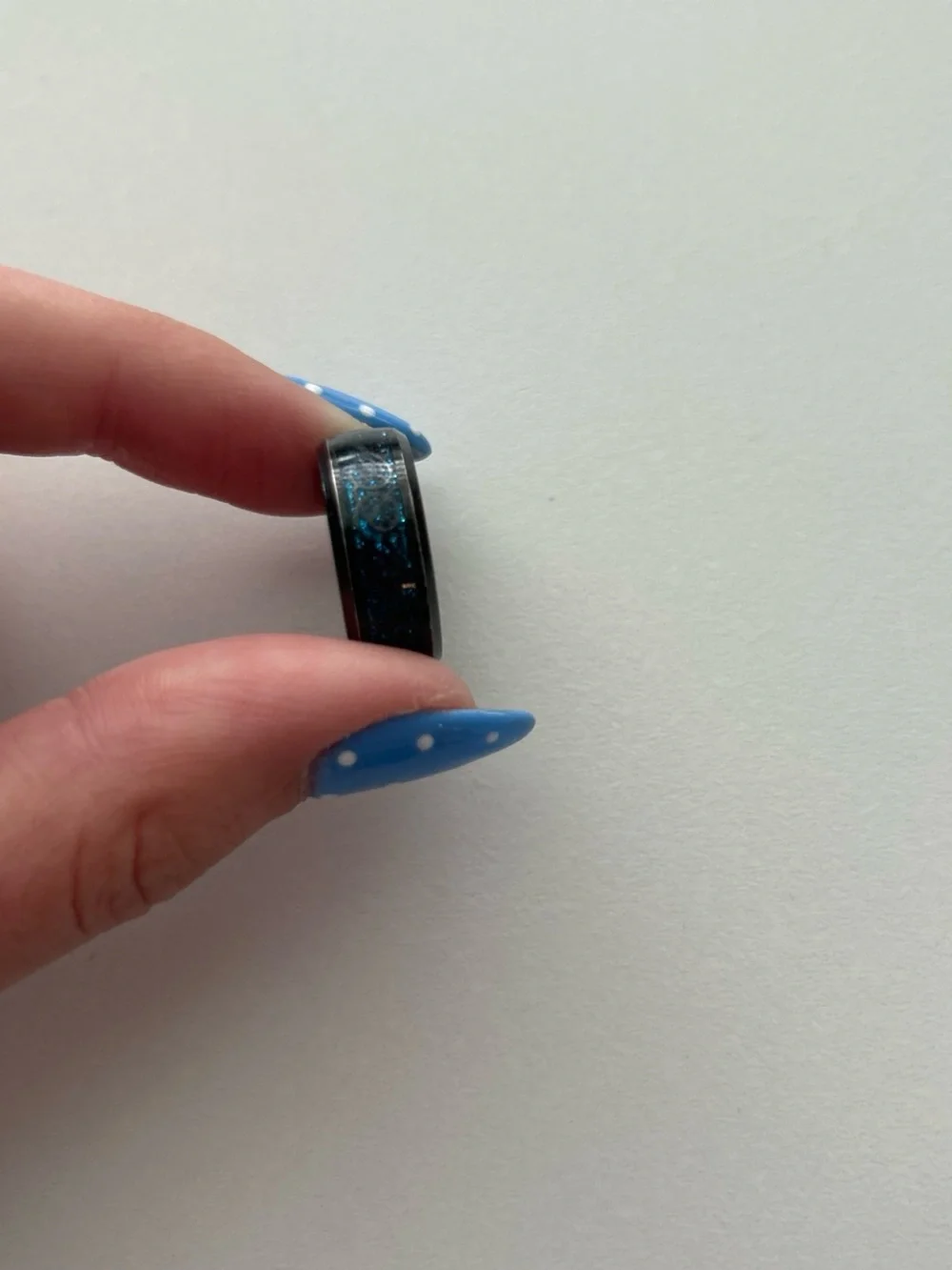 black detailed ring with blue sparkles on the inside